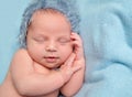 Sweet baby with smile sleeping on hand Royalty Free Stock Photo