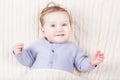 Sweet baby uner a cable kint blanket Royalty Free Stock Photo