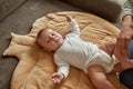 Sweet baby in white bodysuit during dressing Royalty Free Stock Photo