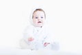 Sweet baby in a white teddy bear snow suit Royalty Free Stock Photo