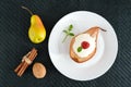 Sweet Baked pear with cream, raspberry syrup, fresh raspberries and mint leaves. Royalty Free Stock Photo