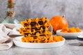 Sweet baked pumpkin waffles on a plate on the table Royalty Free Stock Photo