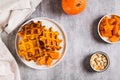 Sweet baked pumpkin waffles on a plate on the table top view Royalty Free Stock Photo