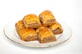 Sweet Baklava on plate on white background.