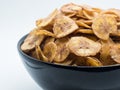 Sweet bananas chip in black bowl isolated on white background. Royalty Free Stock Photo