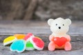 Sweet Bear candle and candy on wooden background.