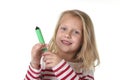 Sweet beautiful female child holding drawing and writing marker school supplies concept