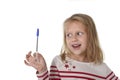 Sweet beautiful female child 6 to 8 years old holding ball pen school supplies concept