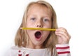 Sweet beautiful female child 6 to 8 years old holding pencil school supplies concept