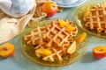 Sweet fluffy classic waffles served with plums Royalty Free Stock Photo