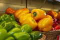 Sweet bell peppers of different colors on a shelf in a store. Close-up. Healthy nutrition and vitamins Royalty Free Stock Photo