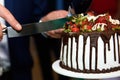 Cutting the celebratory cake with strawberries and cream Royalty Free Stock Photo