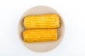 Sweet boiled corn on a white plate