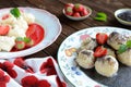 Sweet boiled dumplings filled with strawberries with a poppy seed sauce and curd