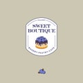 Sweet boutique logo. Bakery and cafe logo. A beautiful cake with blueberries and chocolate on a badge.