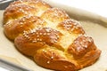 Sweet braided bread on a baking tray