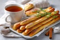 Sweet breadsticks with tea and pastry for breakfast Royalty Free Stock Photo