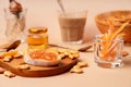 Sweet breakfast with cappuccino in a glass. Beige and orange monochrome color scheme, closeup view