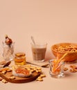 Sweet breakfast with cappuccino in a glass. Beige and orange monochrome color scheme with copy space