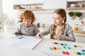 Sweet bright boy helping his sister with homework Royalty Free Stock Photo