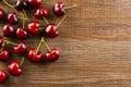 Fresh raw red sweet cherry on brown wood Royalty Free Stock Photo