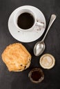 Sweet british raisin scone and a glass filled with honey