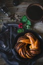 Sweet bun and cup of black coffee on vintage wooden table Royalty Free Stock Photo