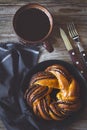 Sweet bun and cup of black coffee on vintage wooden table Royalty Free Stock Photo