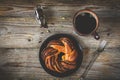 Sweet bun and cup of black coffee on vintage wooden table Royalty Free Stock Photo