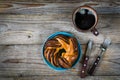 Sweet bun and cup of black coffee on vintage wooden table Royalty Free Stock Photo