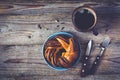 Sweet bun and cup of black coffee on vintage wooden table Royalty Free Stock Photo