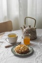 A sweet bun, a cup of tea, honey on the table. Cozy homemade tea party