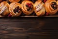 Sweet buns with raspberries and blackberries on wooden background