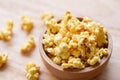 Sweet butter popcorn in bowl on wooden Royalty Free Stock Photo