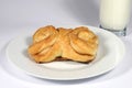 Sweet buttery pastries, cinnamon sugar buns with a glass of cow\'s milk. 1