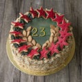Sweet cake with decor on 23 february holiday on light wooden background. Toned. Royalty Free Stock Photo