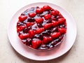 sweet cake with strawberries and cherries on pink Royalty Free Stock Photo