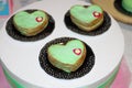 Sweet cakes green hearts are on plates Royalty Free Stock Photo