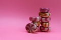 sweet candies caramel on a pink background stacked on top of each other