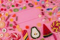 Sweet candies and lollipops on pink wooden table. Royalty Free Stock Photo