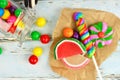 Sweet candies and spilling jar with rustic wood background