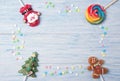 Sweet candies on a stick in shapes of Christmas tree, Gingerbread man and Santa Claus, Christmas frame on a wooden background Royalty Free Stock Photo