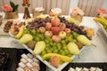 Sweet candy bar.Different delicious fruits and cookies on wedding reception table with bananas and grapes Royalty Free Stock Photo