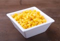 Sweet canned corn in white bowl. Ingredients for salad. Selective focus.