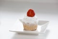Sweet capcake with red strawberry on white plate Royalty Free Stock Photo