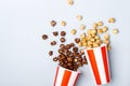 Sweet caramel chocolate popcorn in paper striped white red cup Royalty Free Stock Photo