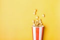 Sweet caramel popcorn in paper striped white red cup Royalty Free Stock Photo