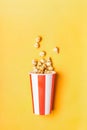 Sweet caramel popcorn in paper striped white red cup Royalty Free Stock Photo