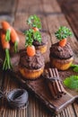 Sweet carrot muffins topped with coconut and chocolate cream