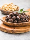 Sweet cashew and chocolate covered nuts on gray stone background